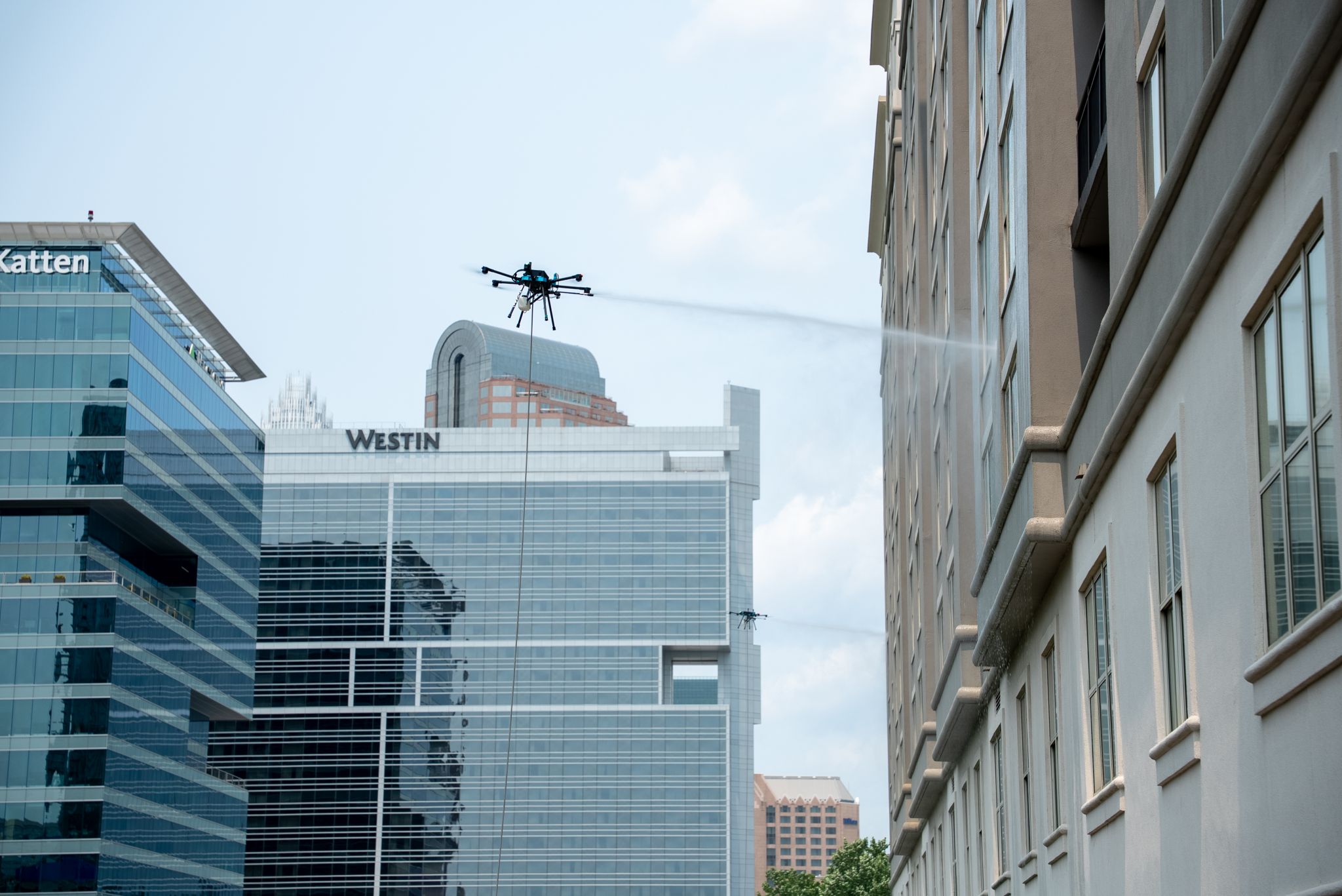 Drone cleaning a commercial building facade
